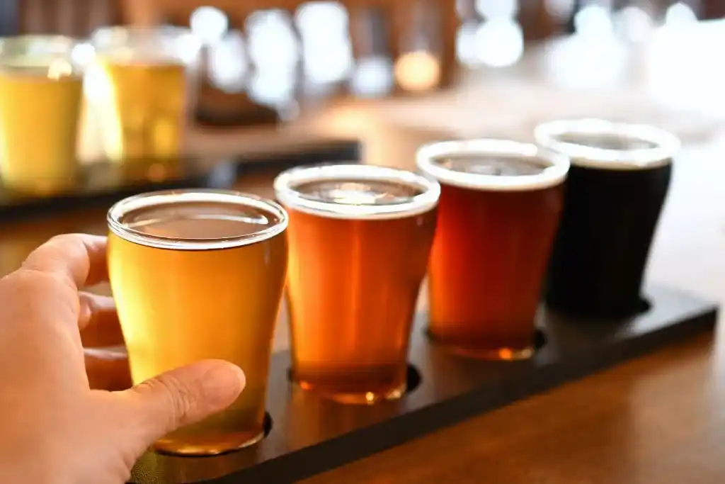 sampling-beer-from-a-flight-of-craft-brew-drinkin-Craft-Breweries-Calgary